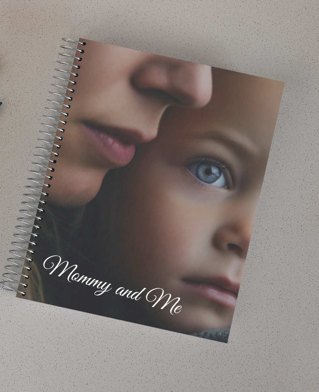 Spiral notebook with a picture of a mother's face close to her daughter's. The words "Mommy and me" at the bottom..
