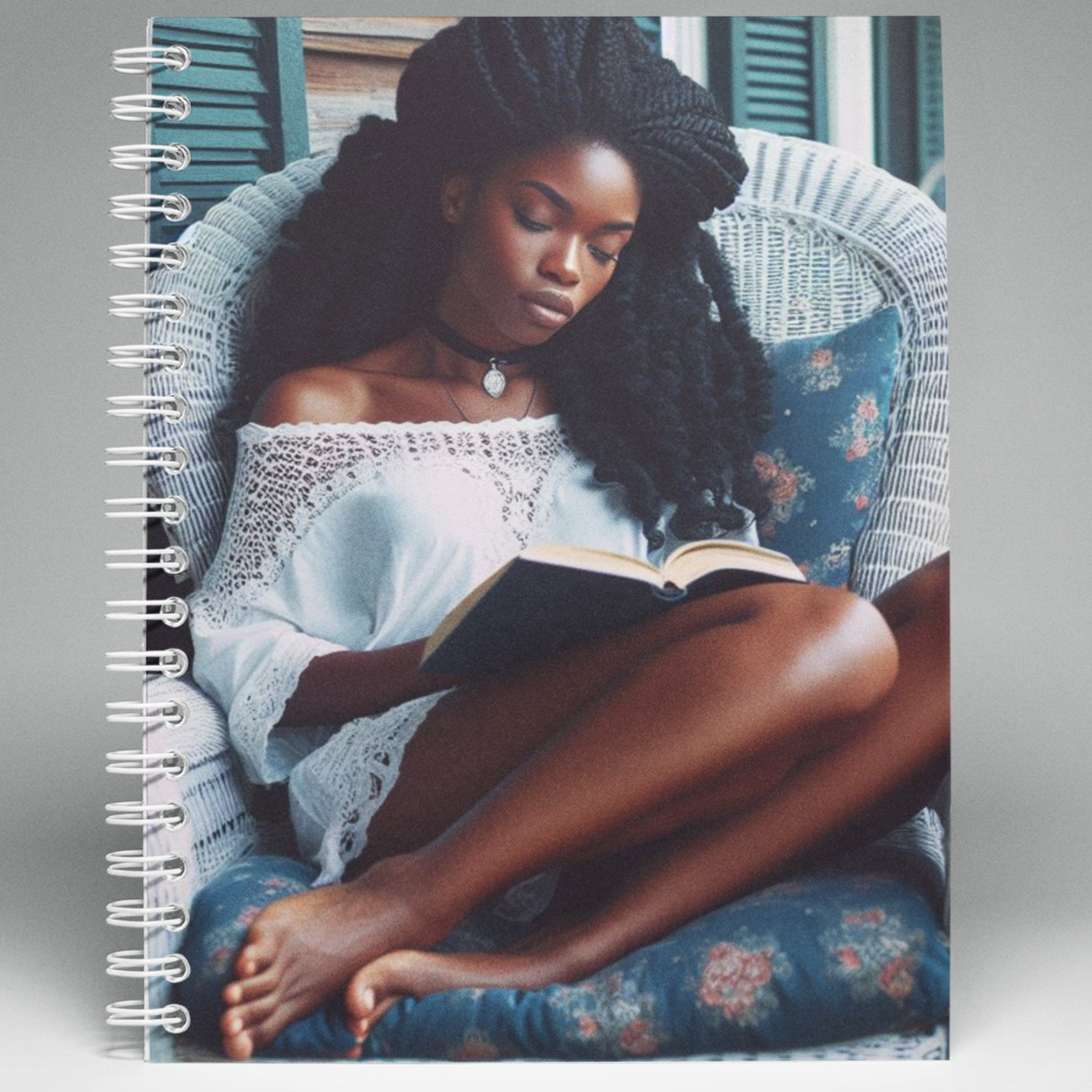 Wired Notebook with a picture of a Black Woman in a wicker chair reading a book.